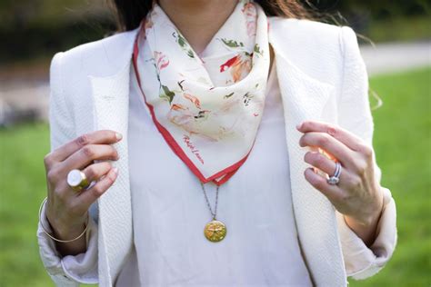 tying a square silk scarf.